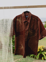 Upena aloha shirt in wine red next to an upena hoolei or throw net